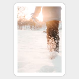 Child running in snow during golden hour Sticker